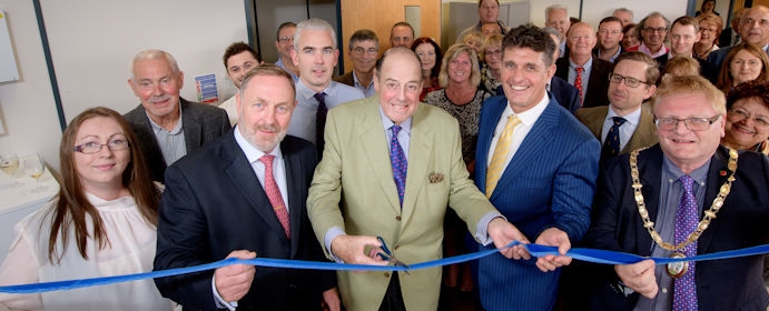 Sir Nicholas cuts the ribbon at the official opening of Mike Oliver Associates in Haywards Heath.