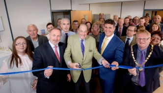 Sir Nicholas cuts the ribbon at the official opening of Mike Oliver Associates in Haywards Heath.