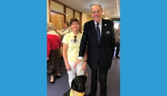 Sir Nicholas at the official opening of Age UK East Grinstead and District with Millie the therapy dog.  